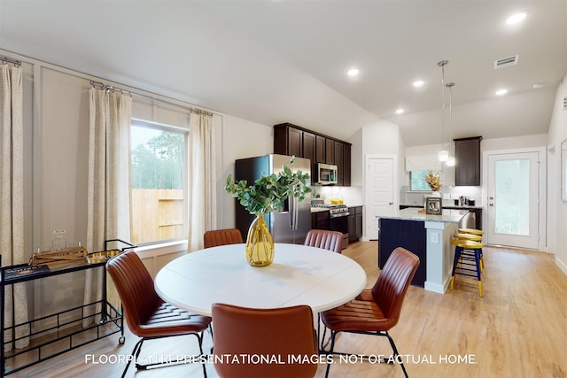 dining area featuring lofted ceiling, visible vents, light wood-style flooring, and recessed lighting