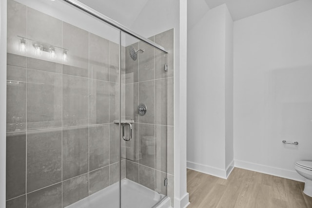26240 Astral Way, La Marque, TX 77568 - full bath with toilet, a shower stall, wood finished floors, and baseboards