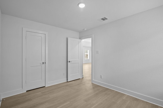26240 Astral Way, La Marque, TX 77568 - unfurnished bedroom featuring baseboards and light wood-style flooring