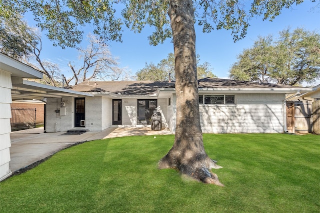 rear view of property with a patio area and a yard