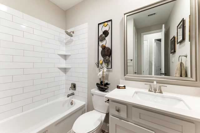 full bathroom with toilet, vanity, and tiled shower / bath