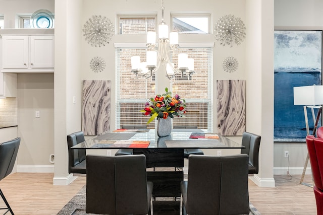 dining area featuring a chandelier and light hardwood / wood-style flooring