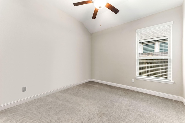 carpeted empty room featuring ceiling fan and vaulted ceiling