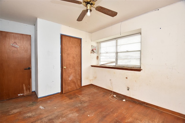 unfurnished bedroom featuring dark hardwood / wood-style flooring and ceiling fan