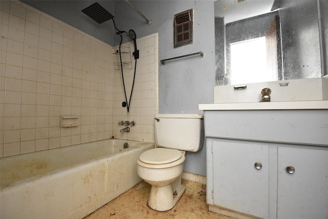 full bathroom featuring tiled shower / bath combo, vanity, and toilet