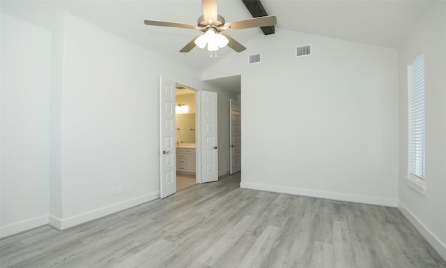 unfurnished bedroom with vaulted ceiling with beams, ensuite bath, ceiling fan, and light wood-type flooring