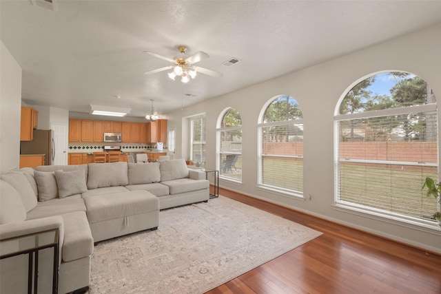 living room featuring light hardwood / wood-style flooring and ceiling fan