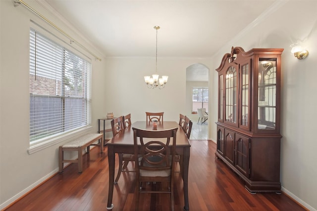 dining area with a chandelier, crown molding, and dark hardwood / wood-style flooring