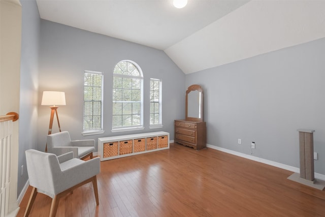 sitting room featuring hardwood / wood-style floors and lofted ceiling