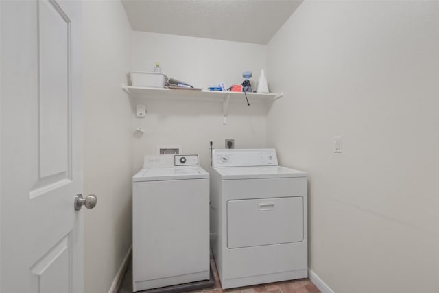 laundry room featuring a textured ceiling, washer and clothes dryer, and light wood-type flooring