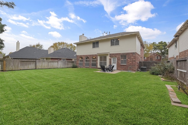 back of property featuring a patio area and a yard