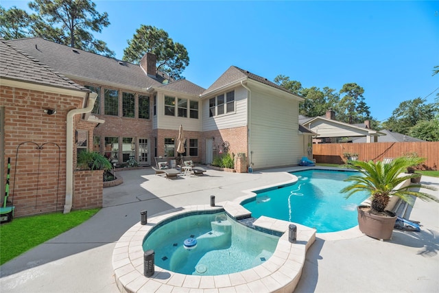 view of swimming pool with a patio area and an in ground hot tub