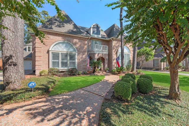 english style home with a front lawn