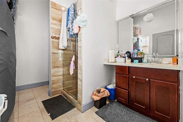 bathroom featuring tile patterned floors, a shower with shower door, and vanity