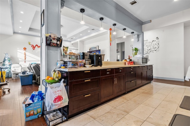 kitchen with a raised ceiling and hanging light fixtures