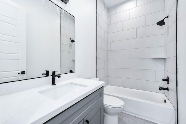 full bathroom featuring toilet, tiled shower / bath, and vanity