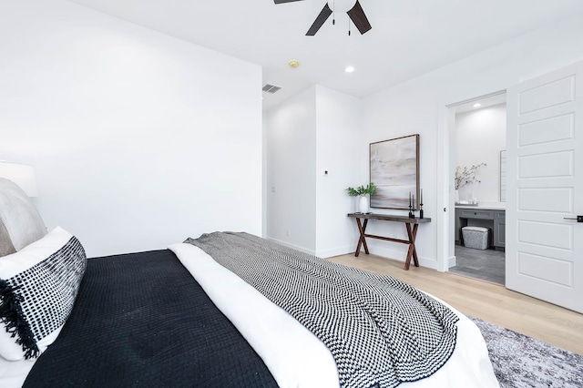 bedroom featuring ceiling fan, light hardwood / wood-style flooring, and ensuite bathroom