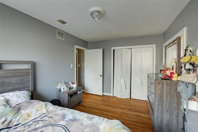 bedroom with a closet and hardwood / wood-style flooring