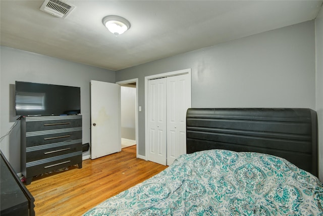 bedroom with a closet and light hardwood / wood-style flooring