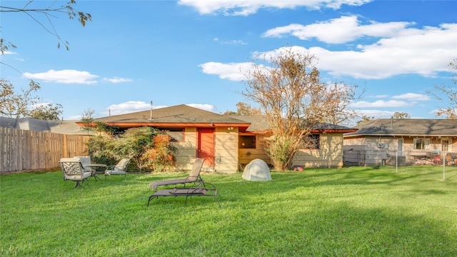 back of house with a lawn