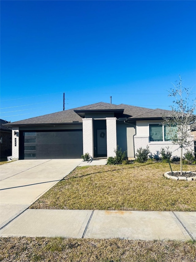 view of front of property with a garage and a front yard