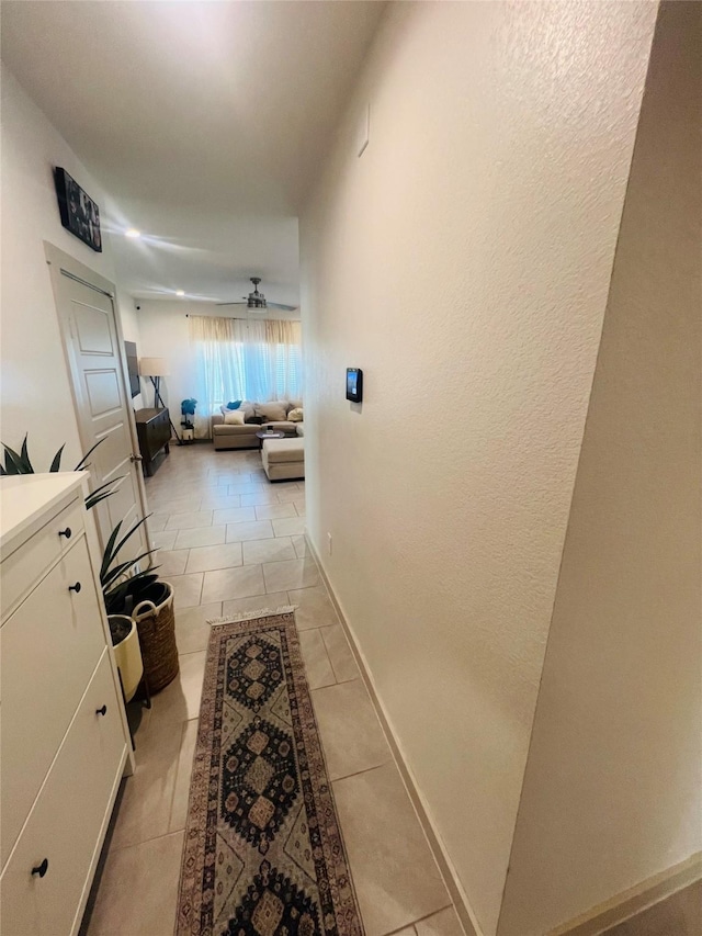 hall featuring light tile patterned floors