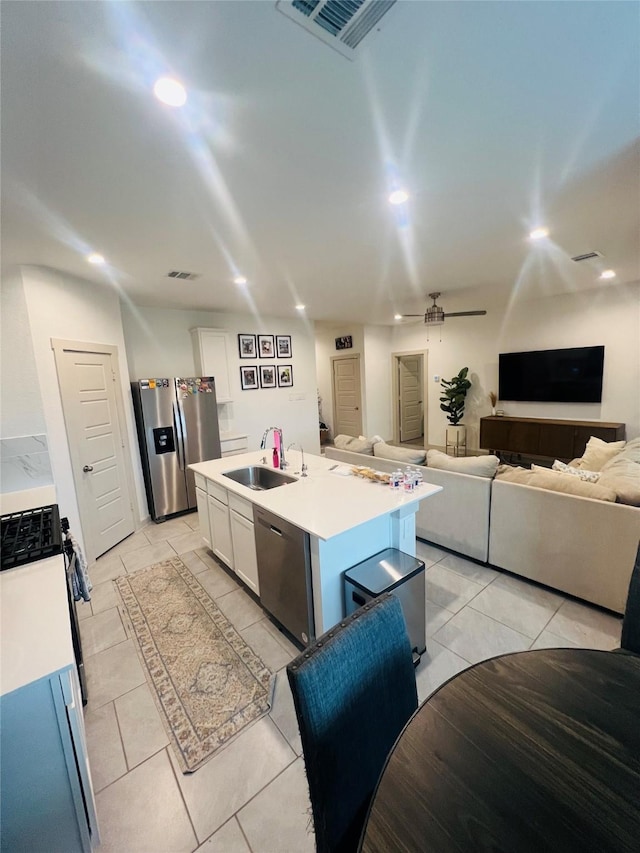 kitchen featuring a kitchen island with sink, sink, white cabinetry, and appliances with stainless steel finishes