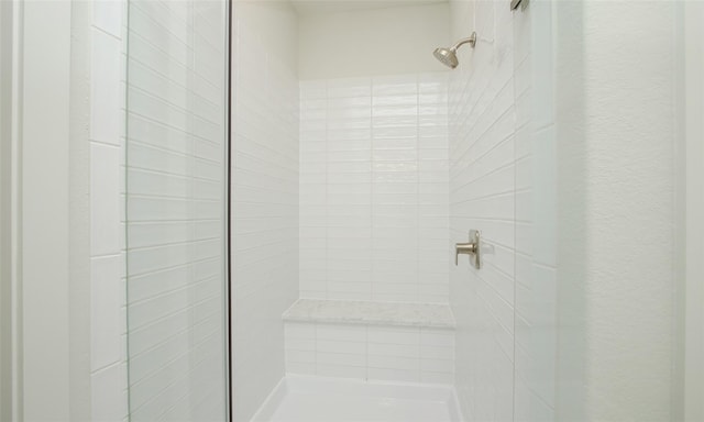 bathroom with tiled shower