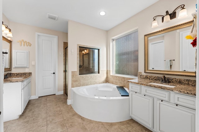 bathroom featuring vanity, separate shower and tub, and tile patterned flooring