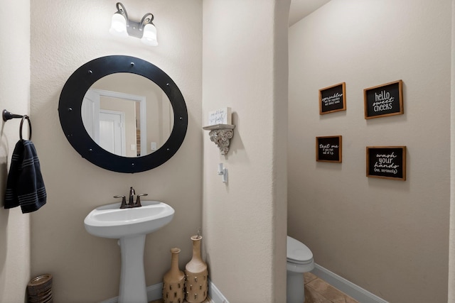 bathroom featuring tile patterned floors and toilet