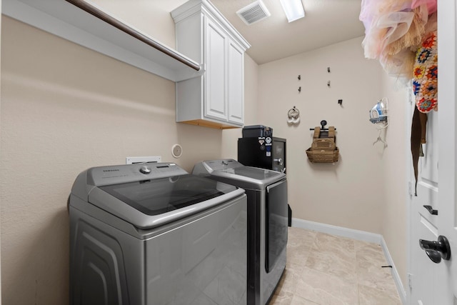 laundry area with cabinets and independent washer and dryer