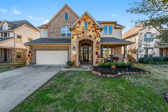 view of front of home featuring a garage, a front yard, and covered porch