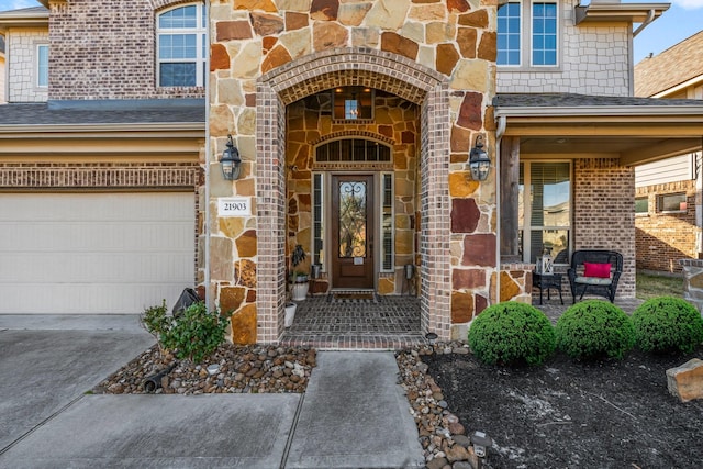 entrance to property featuring a garage and a porch