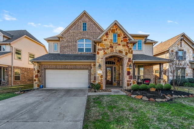 view of front of property featuring a porch, a garage, and a front yard