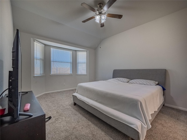 bedroom featuring ceiling fan, light colored carpet, and vaulted ceiling