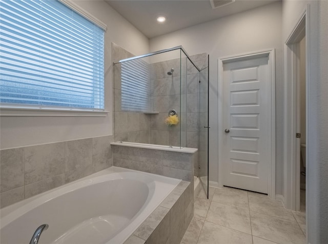 bathroom featuring toilet, separate shower and tub, and tile patterned flooring