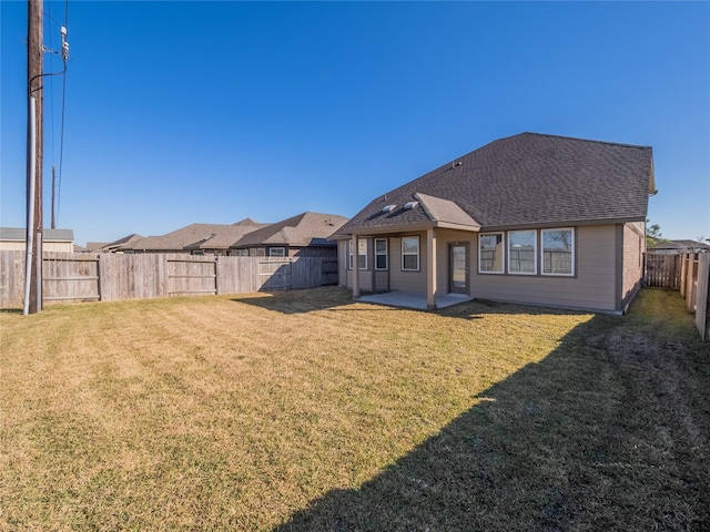 rear view of property with a patio and a yard