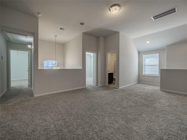 unfurnished living room with lofted ceiling and carpet floors