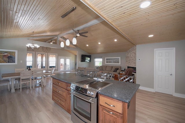 kitchen with brown cabinets, light wood-style floors, open floor plan, stainless steel range with electric cooktop, and a kitchen island