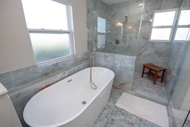 bathroom featuring independent shower and bath and tile walls