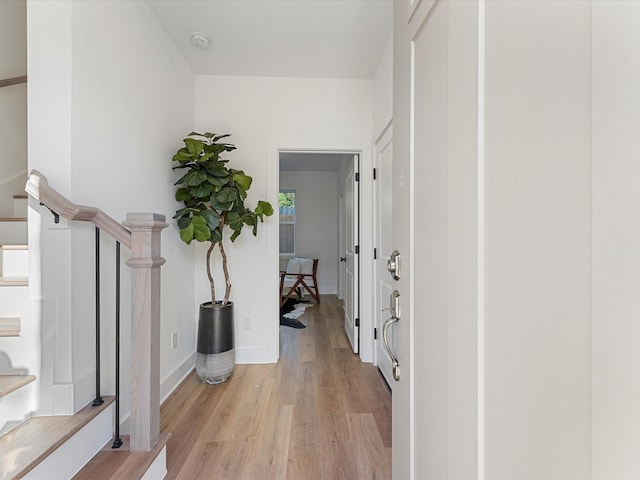 corridor with light hardwood / wood-style floors