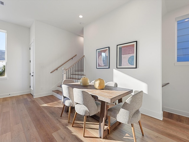 dining space with light hardwood / wood-style flooring