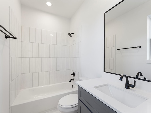 full bathroom featuring toilet, tiled shower / bath, and vanity