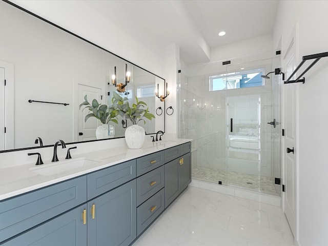 bathroom featuring a shower with shower door and vanity