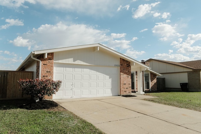 view of side of property featuring a yard and a garage