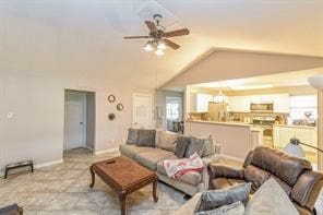 living room featuring vaulted ceiling and ceiling fan