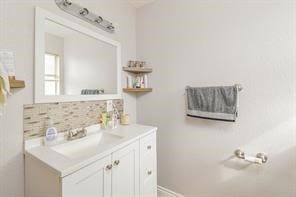 bathroom featuring decorative backsplash and vanity