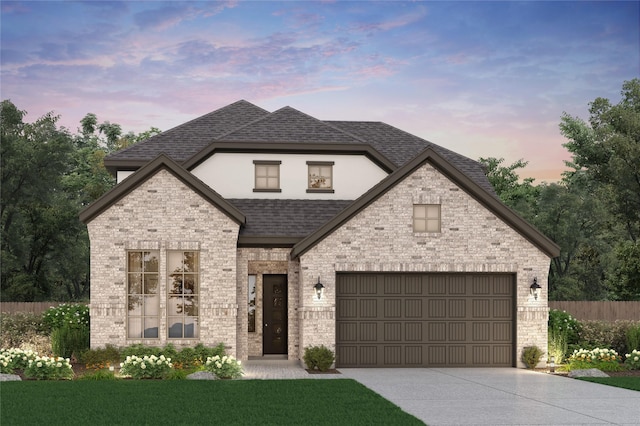 french country inspired facade with fence, driveway, roof with shingles, a garage, and brick siding