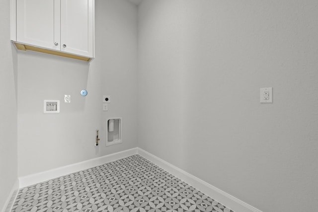 laundry area featuring electric dryer hookup, baseboards, cabinet space, and gas dryer hookup