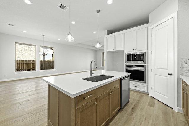 kitchen with recessed lighting, visible vents, appliances with stainless steel finishes, and a sink